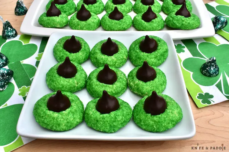 Hershey's Kisses atop a green sugar cookies on plates