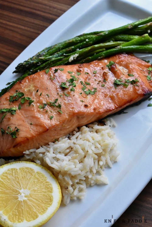 Healthy Maple Glazed Salmon with white rice and asparagus on a plate with a lemon wedge