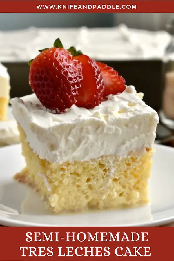 Semi-Homemade Tres Leches Cake with whipped cream frosting and topped with a strawberry