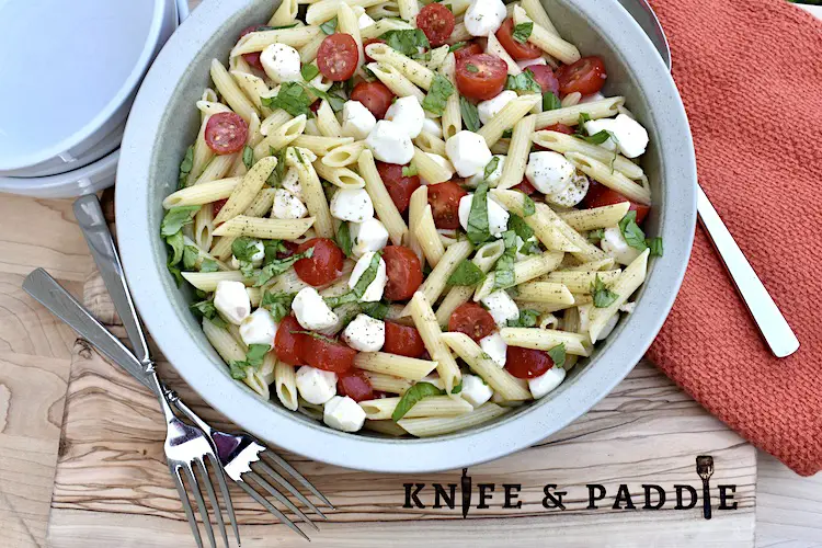Caprese Penna Pasta Salad in a large serving bowl