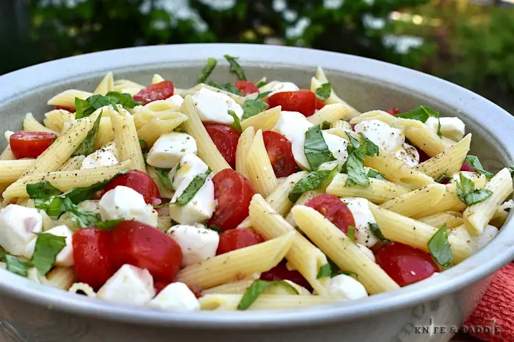 Caprese Penna Pasta Salad in a large serving bowl