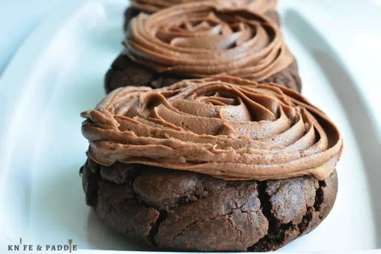 Copycat Chocolate Crumbl Cookies on a plate frosted with chocolate buttercream frosting