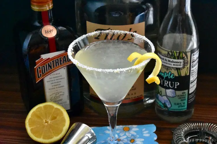 Cointreau, Tito's, Simple Syrup and fresh squeezed lemon juice shaken until cold and strained in a sugar and lemon zest rimmed martini glass
