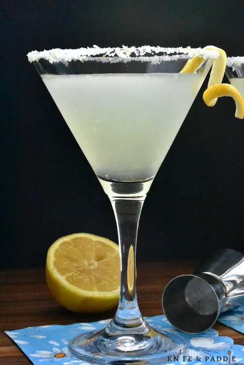 Lemon Drop Martini served in a sugar and lemon zest rimmed martini glass garnished with a lemon twist