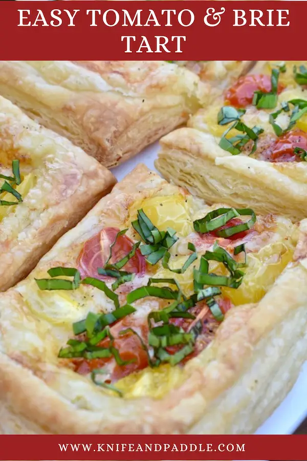 Puff Pastry topped with brie cheese, yellow and red grape tomatoes baked to a golden brown and topped with fresh basil