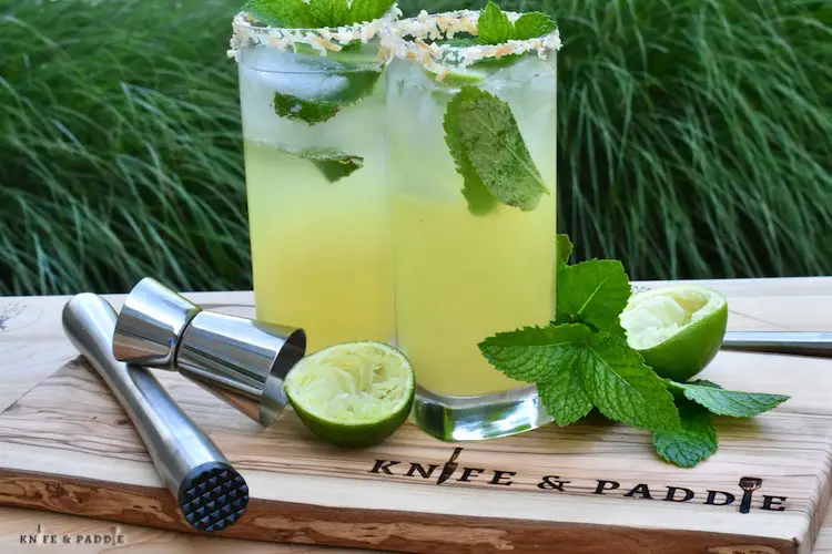 Delicious tropical cocktail with fresh mint and a garnished rim