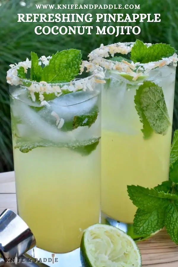 Refreshing Pineapple Coconut Mojito with a toasted coconut rimmed glass and fresh mint spring for garnish