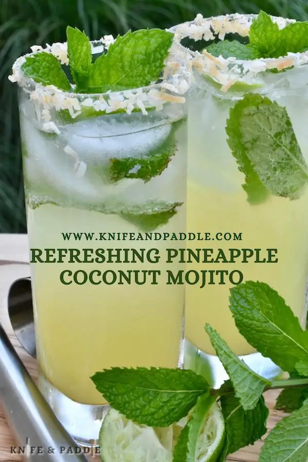 Refreshing Pineapple Coconut Mojito with a toasted coconut rimmed glass and fresh mint spring for garnish