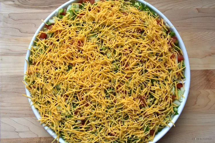 Shredded cheddar cheese added to the best taco dip