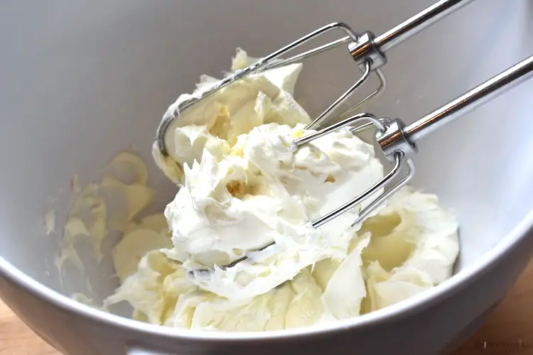 Beating the cream cheese in a bowl