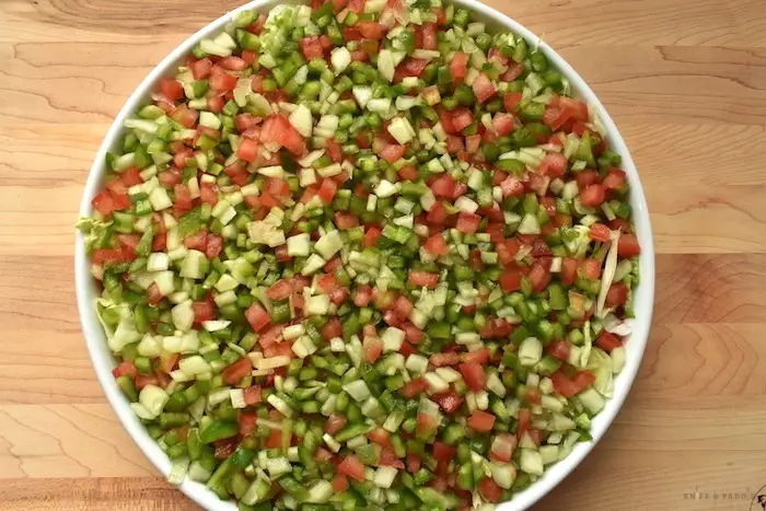 lettuce then vegetables layers in the best taco dip