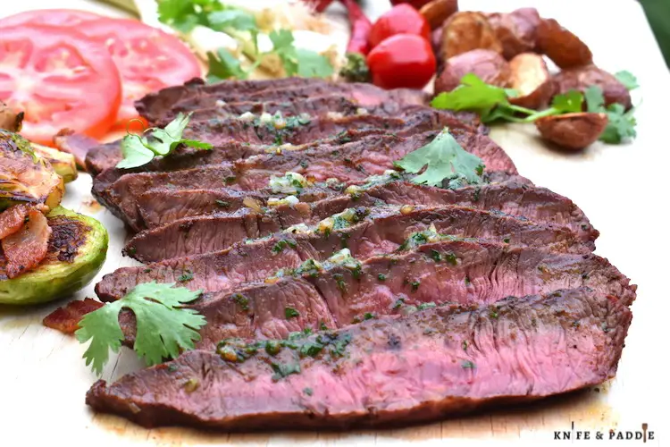 Chili-Rubbed Flat Iron Steak with Cilantro Compound Butter, Grilled Vegetables and Spices