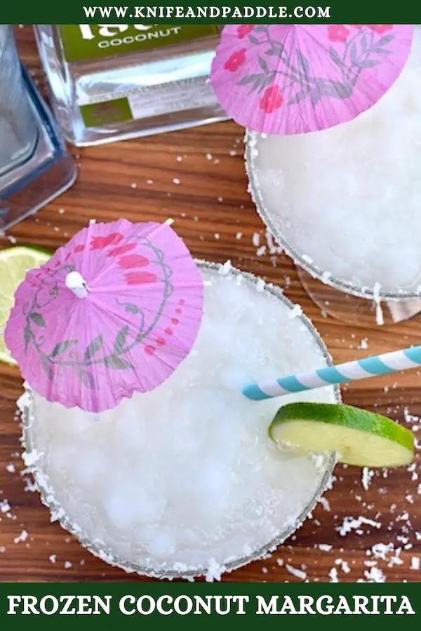 Frozen Coconut Margarita with a coconut-salt rim, lime wheel and a cocktail umbrella