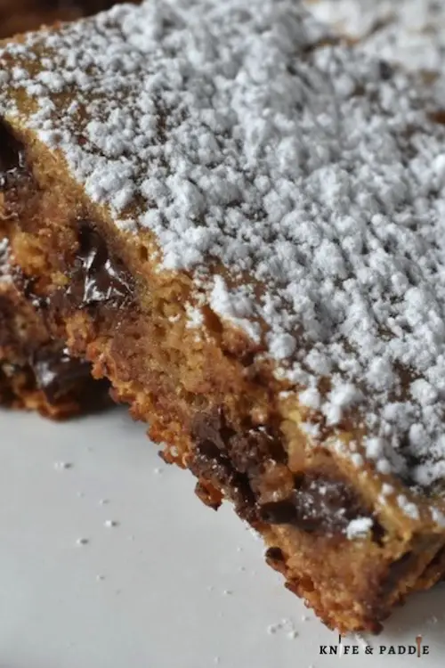 Simple & Delicious Graham Cracker Bars on a plate with powdered sugar