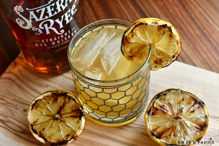 Grilled Whiskey Sour with grilled lemons and garnished with a grilled lemon wheel