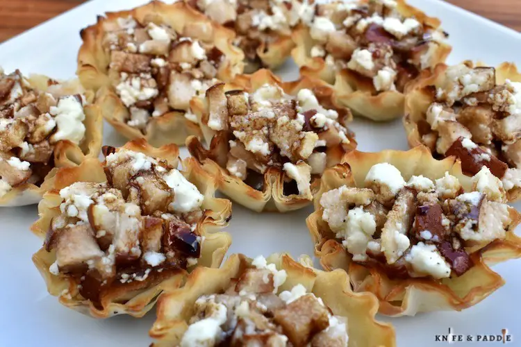 Pear & Goat Cheese Phyllo Cups on a plate with balsamic glaze or honey drizzle