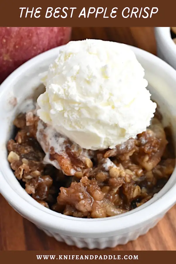 The Best Apple Crisp in a bowl topped with vanilla ice cream