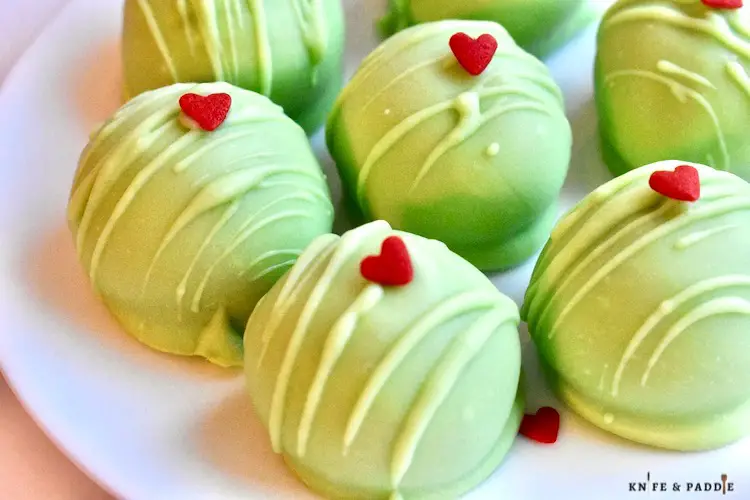 Grinch Oreo Balls with a red candy heart