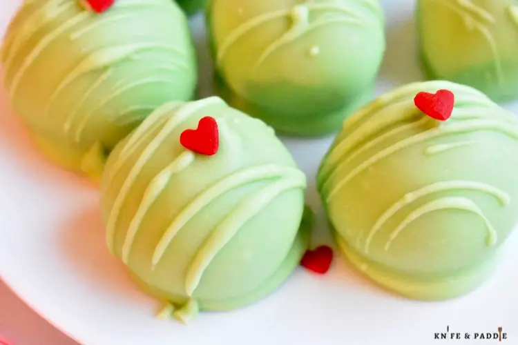 Grinch Oreo Balls with a red candy heart