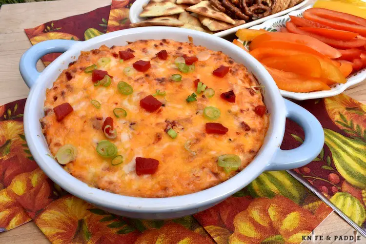 Easy holiday appetizer baked and served with crackers, pita chips, pretzels and sliced peppers