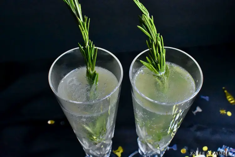 Eldeflower liqueur, gin, lemon juice, simple syrup shaken and strained into a flute topped off with prosecco and garnished with a rosemary sprig