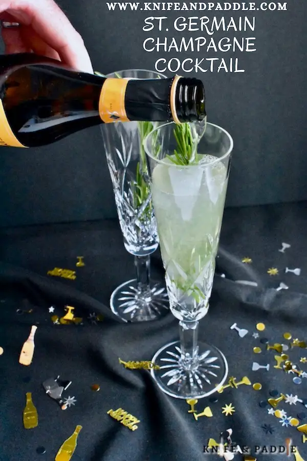 St. Germain Champagne Cocktail garnished with a rosemary sprig