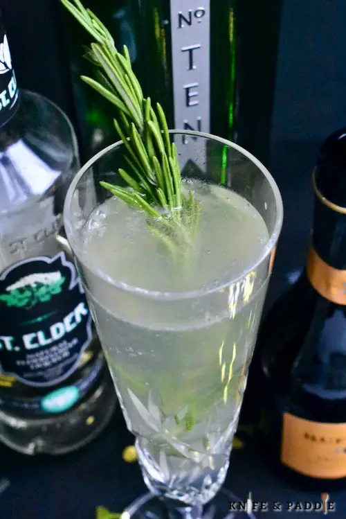 St. Germain Champagne Cocktail garnished with a rosemary sprig