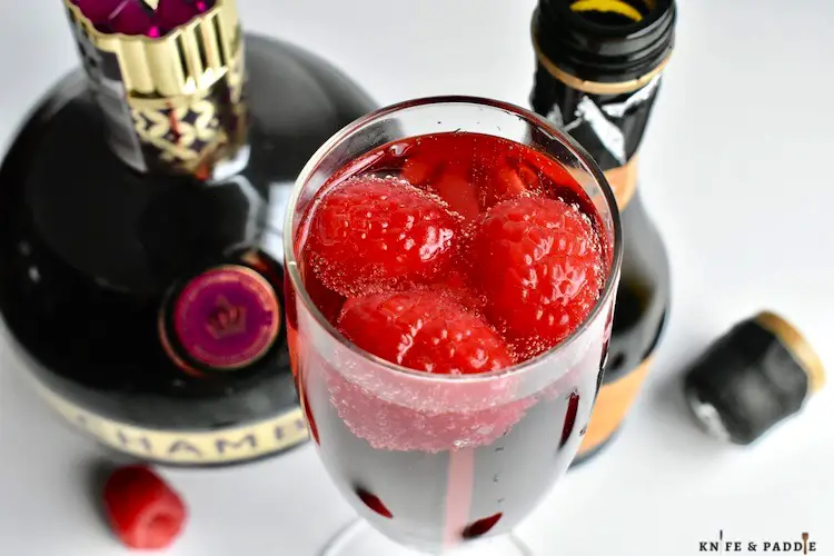 Chambord and Champagne Cocktail topped with fresh raspberries