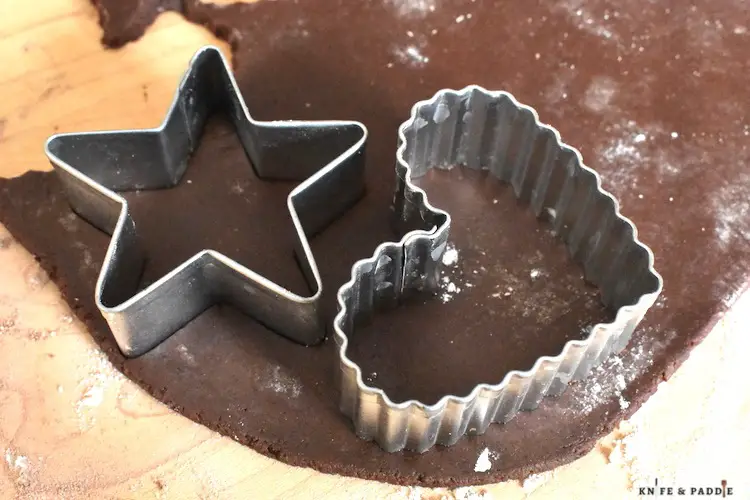 Chocolate dough with a star and heart cookie cutter