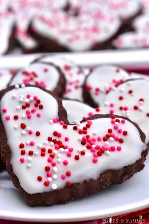 Cute Valentine's Day treats with vanilla frosting and red, white and pink nonpareils 