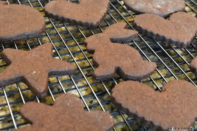 Chocolate cutout cookies cooling on a wire rack