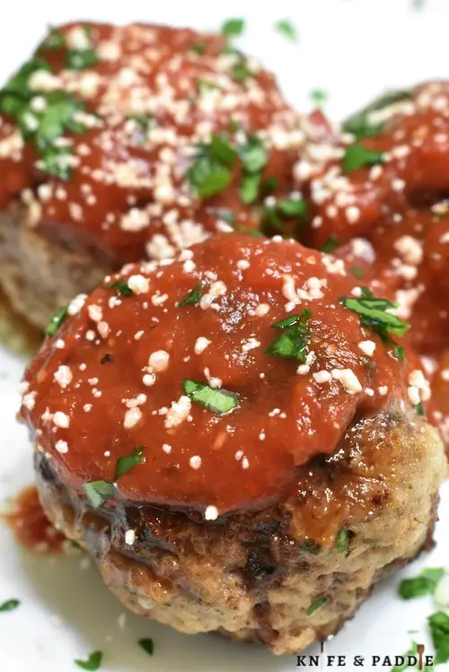 Classic Italian Meatballs with a Simple Homemade Tomato Sauce and topped with parmesan cheese and fresh parsley