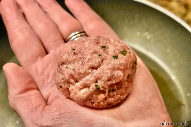 Rolled meatball in the palm of a hand