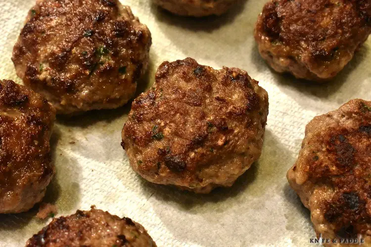 Crispy fried meatballs placed on paper towels