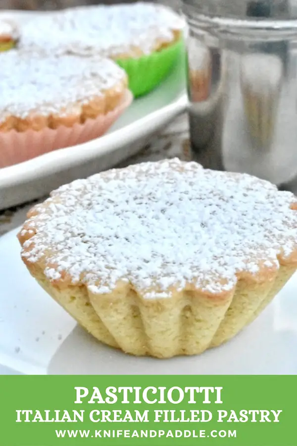 Pasticiotti Italian cream filled pastry on plates sprinkled with powdered sugar