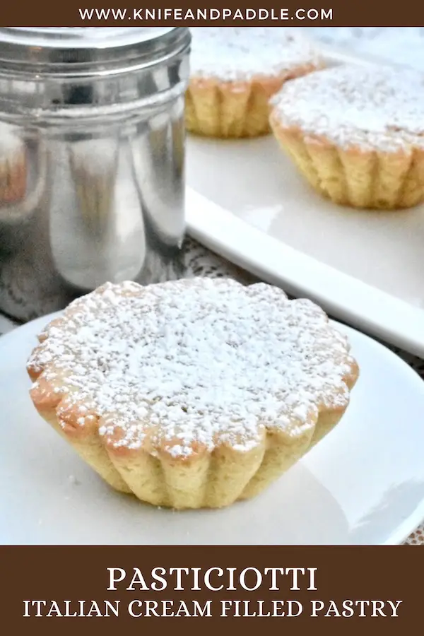 Pasticiotti Italian cream filled pastry on plates sprinkled with powdered sugar