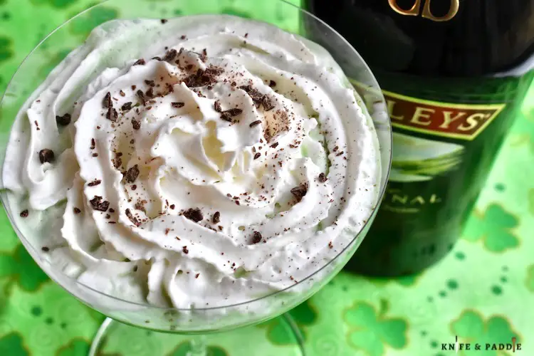 Baileys Mint Martini made with Crème de Menthe, Crème de Cacao and Baileys Irish Cream and served in a coup glass, garnished with whipped cream and chocolate shavings