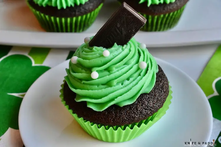 Mint Chocolate Cupcakes topped with bright green buttercream frosting, white pearls and an Andes Mint 