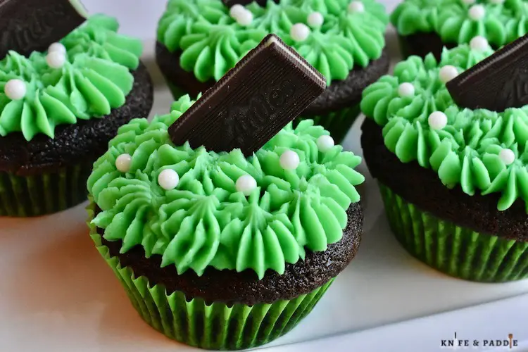 St. Patrick's Day Desserts on a plate with bright green buttercream frosting and topped with an Andes candy