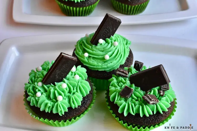 St. Patrick's Day Desserts on a plate with bright green buttercream frosting and topped with an Andes candy