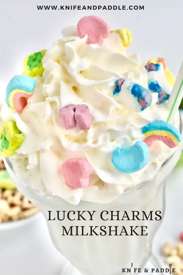 Lucky Charms Milkshake topped with whipped cream and Lucky Charms marshmallows