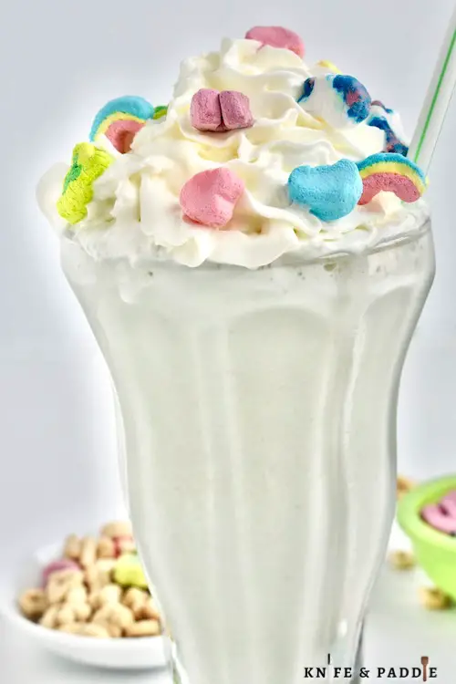 Fun cereal ice cream drink topped with whipped cream and colorful marshmallows