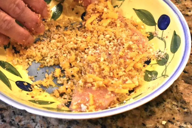 Italian seasoned panic bread crumbs in a mixing bowl with shredded cheddar cheese 