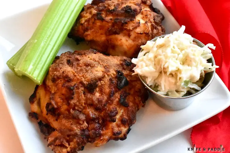 Air Fryer Chicken on a plate with celery and cole slaw