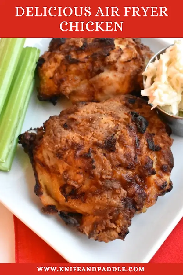 Delicious Air Fryer Chicken on a plate with celery sticks and coleslaw 
