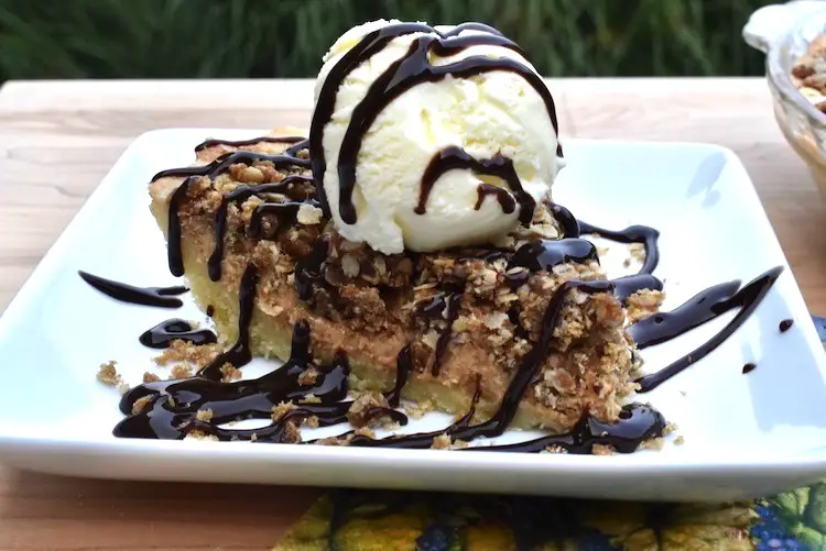 The Most Delicious Peanut Butter Pie with vanilla ice cream and chocolate drizzle