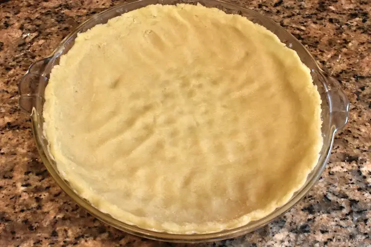 dough pressed into a baking dish lightly sprayed with baking spray with flour