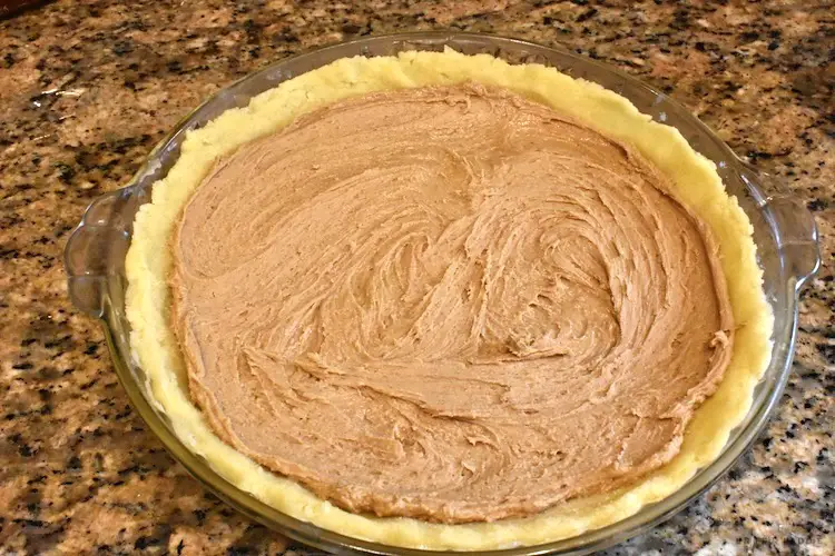 Creamy peanut butter filling into pie shell