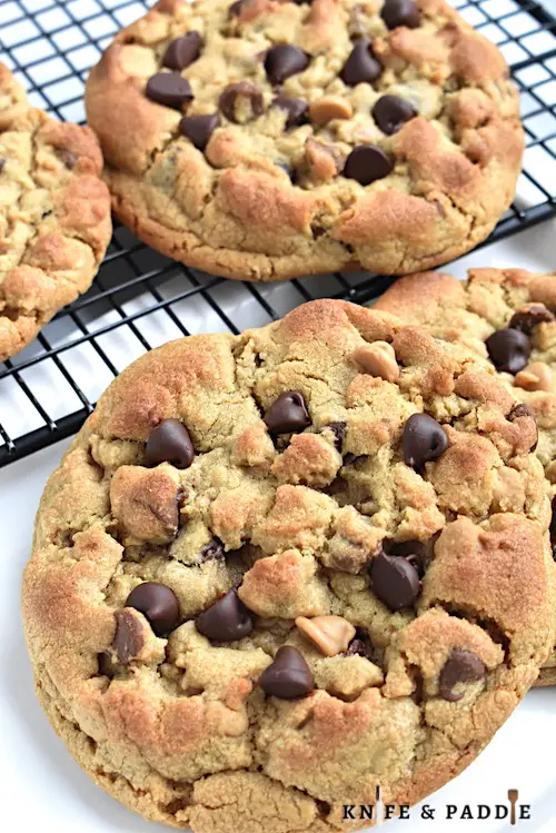 Bakery-Style Peanut Butter Chocolate Chip Cookies in a dish and on a wire rack