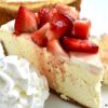 Classic Cheesecake with fresh strawberries and whipped cream